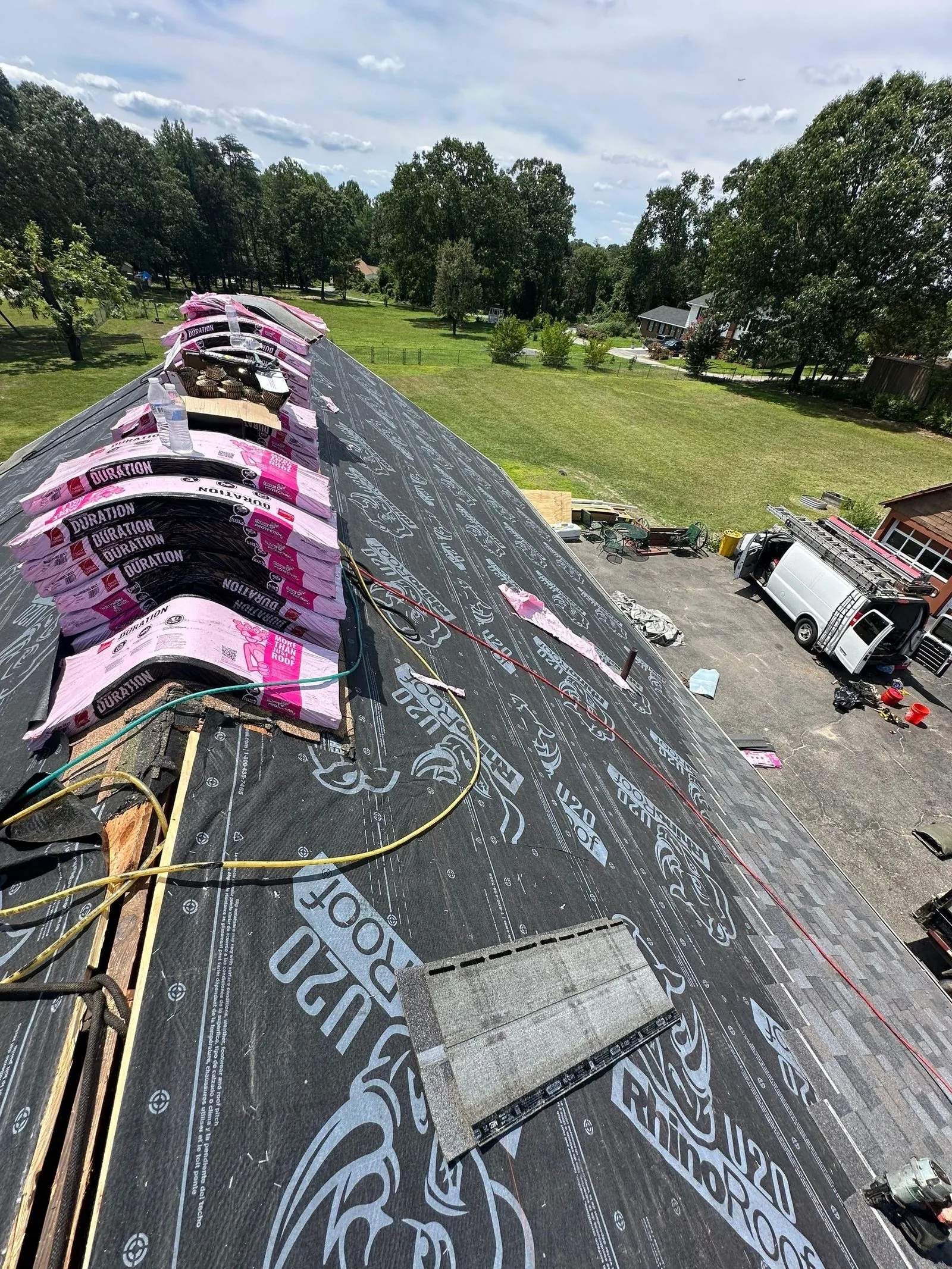 Underlayment down and Owens Corning shingle bundles staged for install