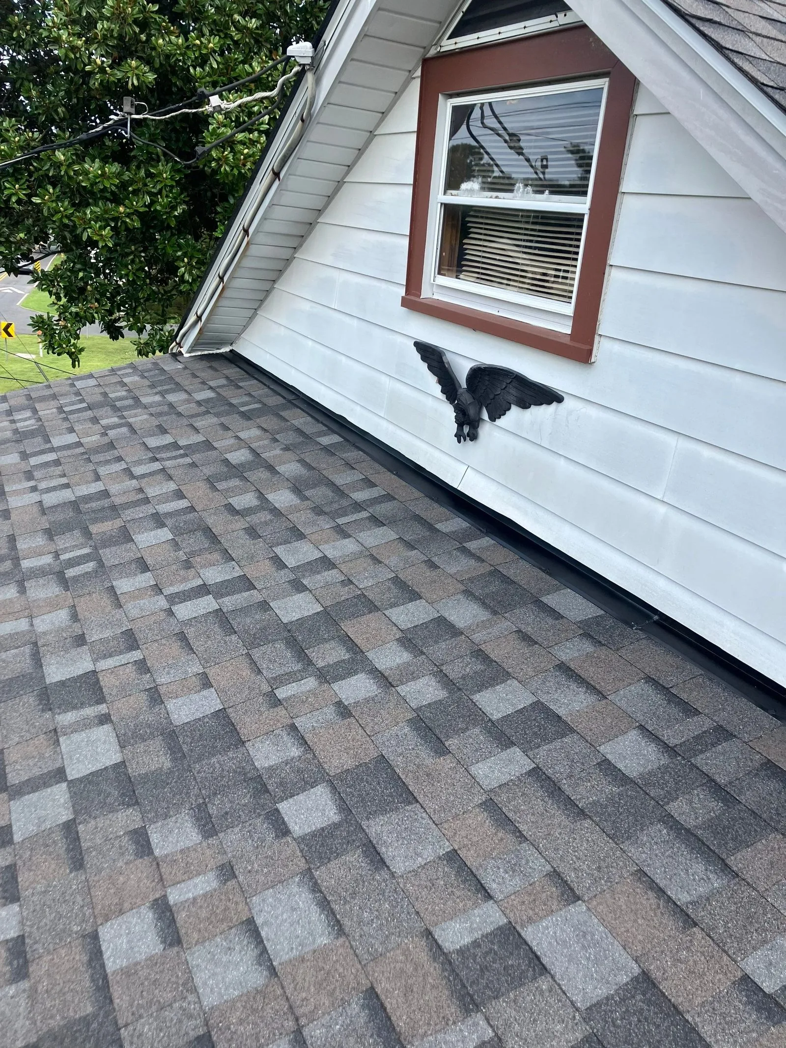 Finished shingle slope at the gable end and dormer after replacement